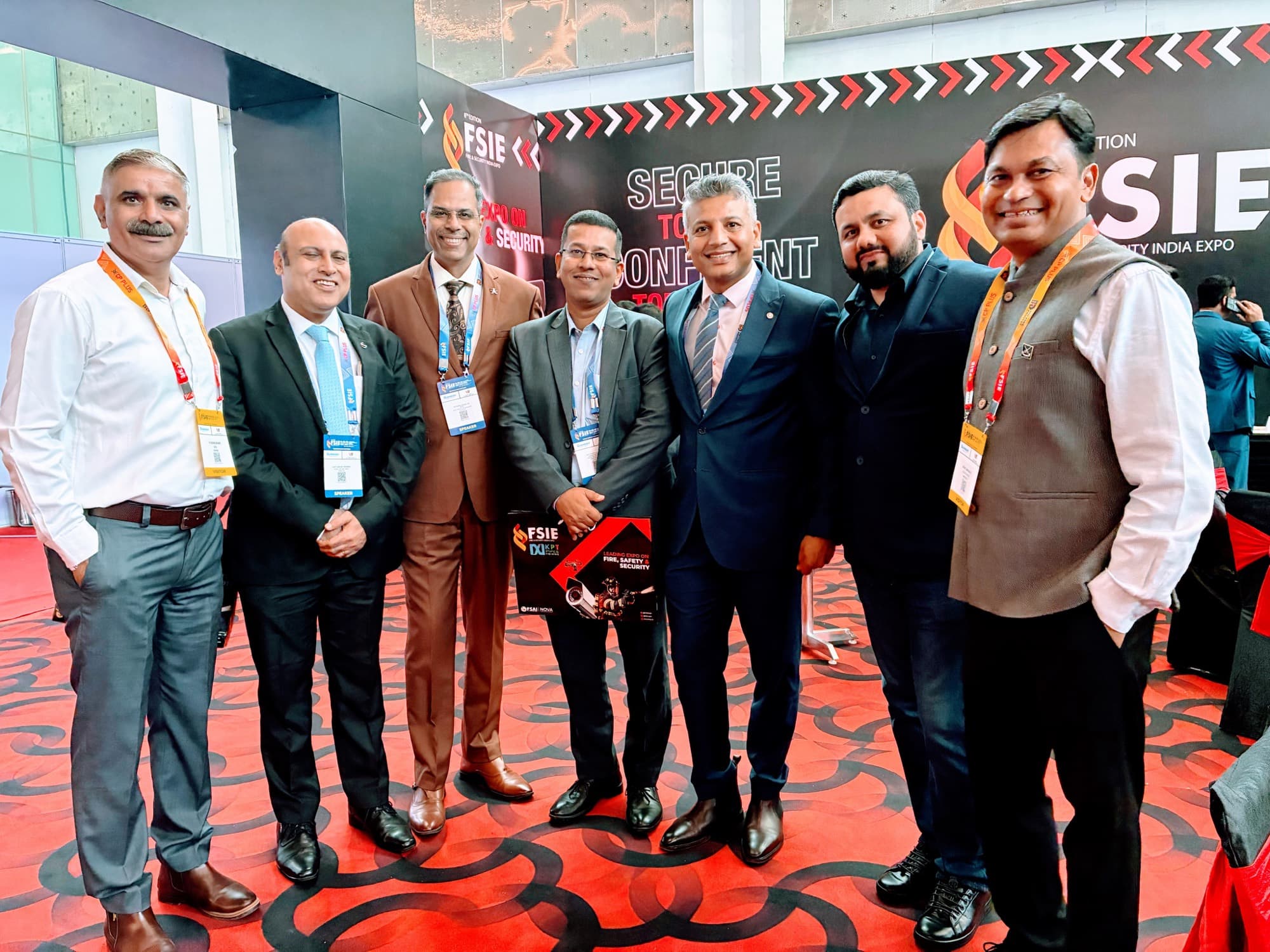 Curated event attendees standing together at a conference booth